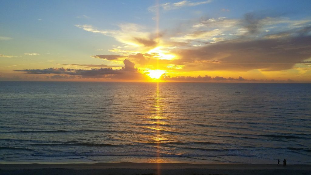 Consultation appointment photo of rising sun on water bringing warmth and light