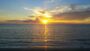 Consultation appointment photo of rising sun on water bringing warmth and light